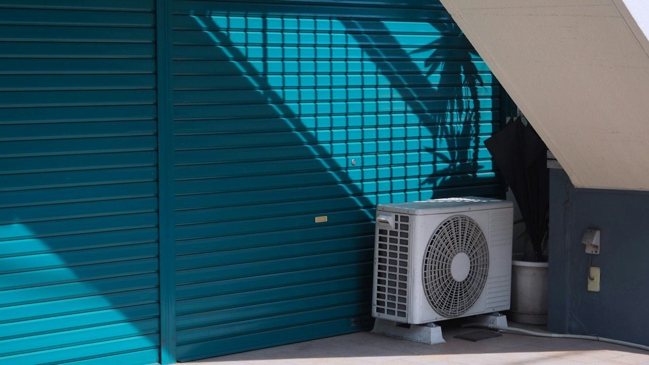 Outdoor air conditioning unit beside a building.