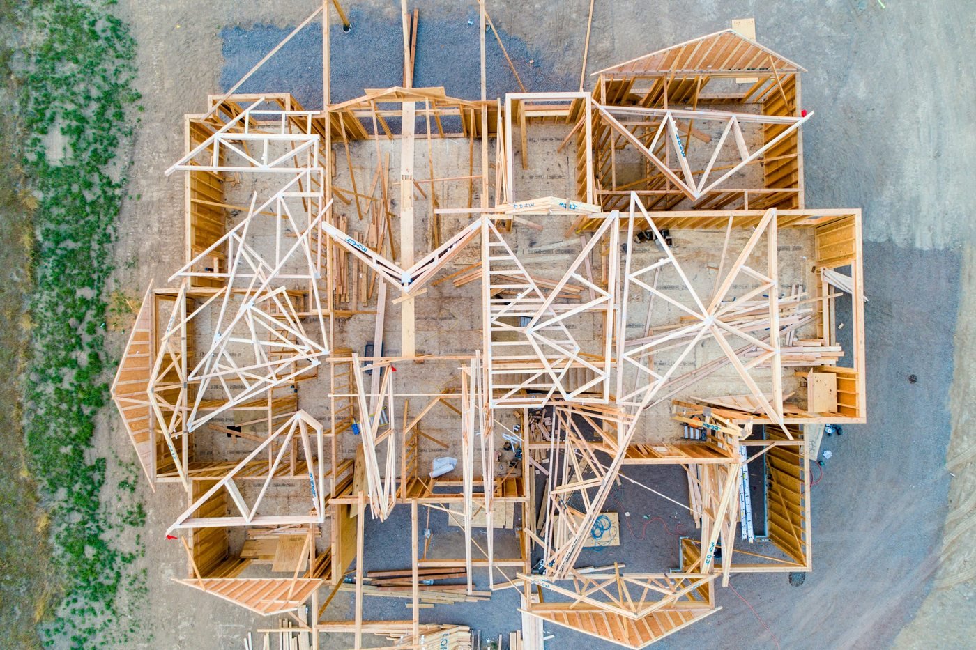 Overhead view of the wooden frame and room layout of a house under construction