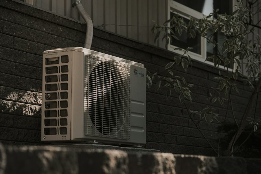 Outdoor air conditioning unit installed beside a house.