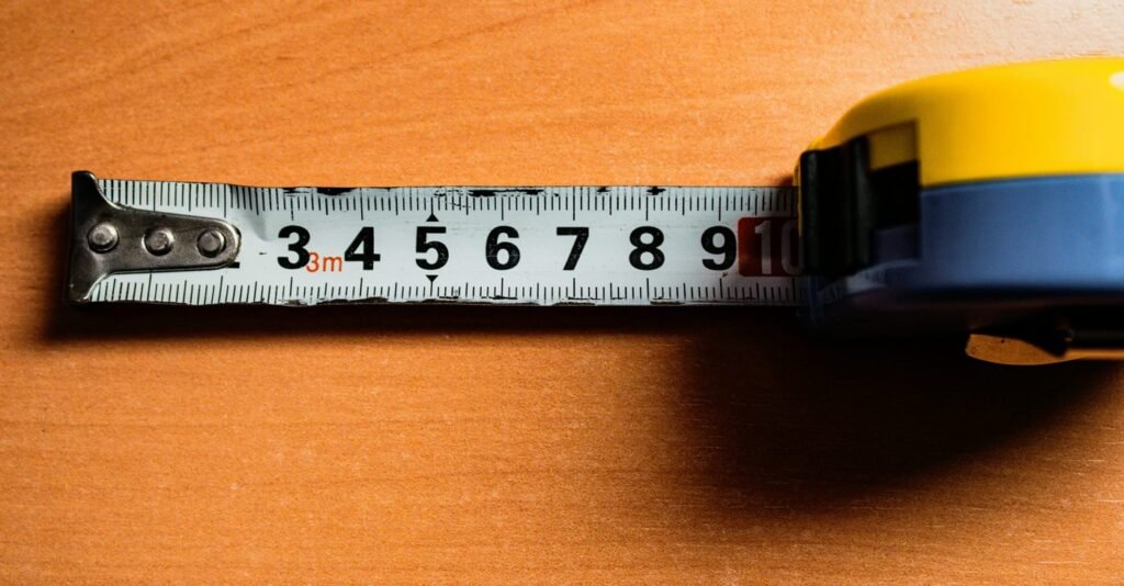 Extended tape measure with centimetre markings on a wooden surface