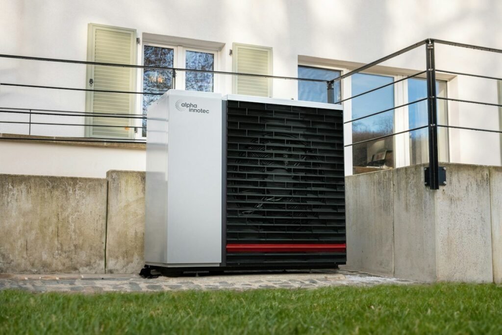 Outdoor heat pump installed in front of a home.