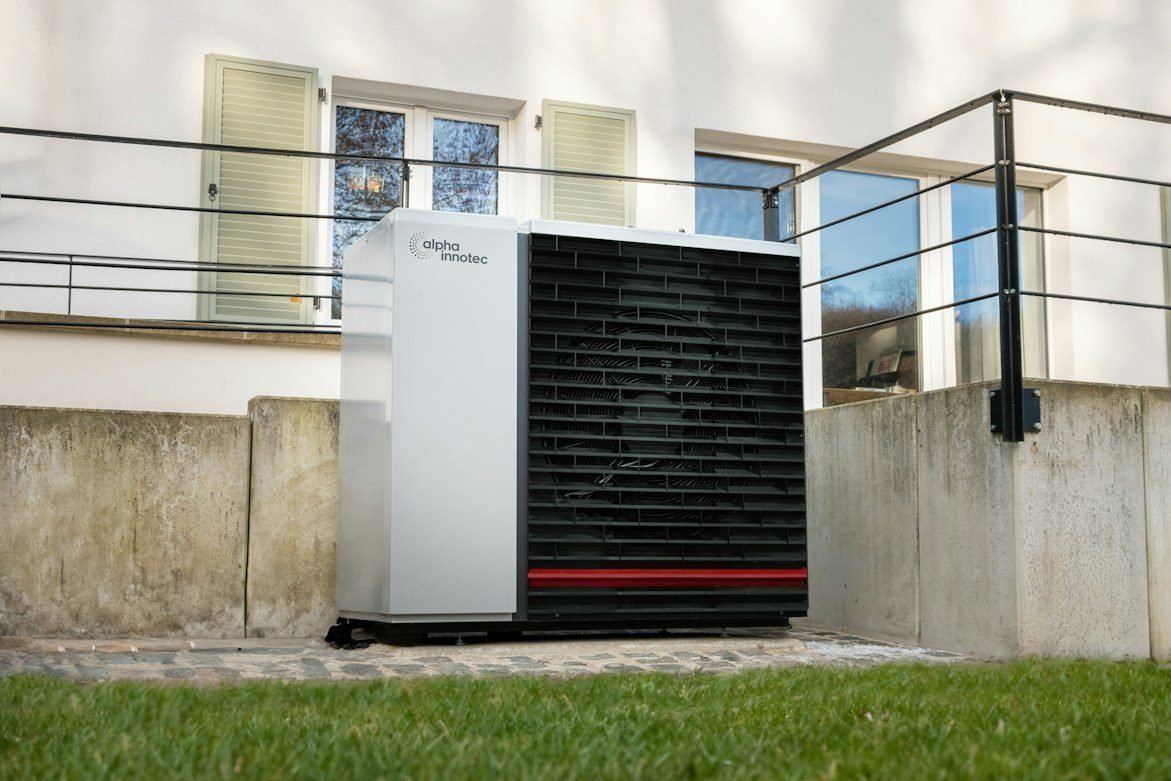 Outdoor heat pump installed in front of a home.