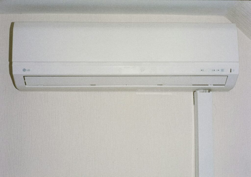 White wall-mounted indoor air conditioning unit.