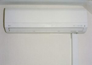 White wall-mounted indoor air conditioning unit.