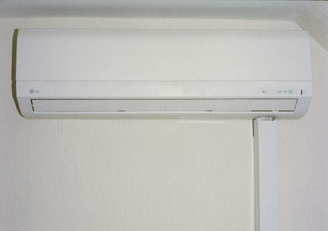 White wall-mounted indoor air conditioning unit.